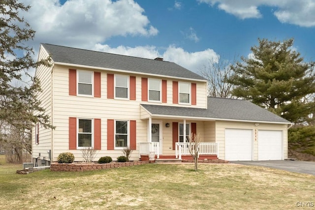 view of front of property featuring an attached garage, covered porch, a shingled roof, a front lawn, and aphalt driveway