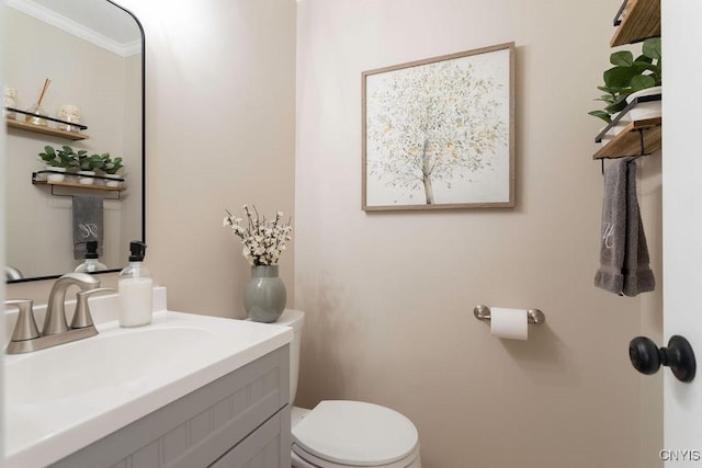 bathroom with crown molding, toilet, and vanity