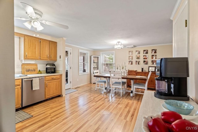 kitchen with a ceiling fan, light wood-style flooring, light countertops, dishwasher, and crown molding