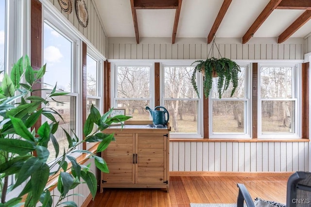 sunroom featuring beamed ceiling