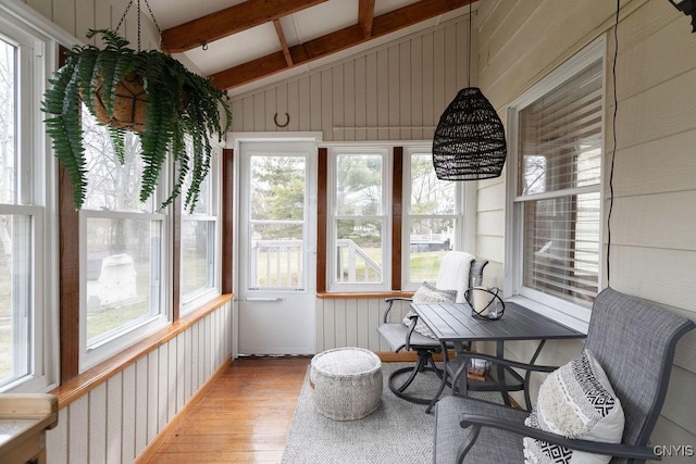 sunroom / solarium with lofted ceiling with beams