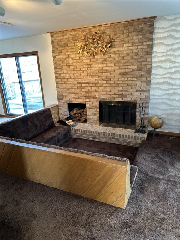 unfurnished living room with a brick fireplace and carpet floors