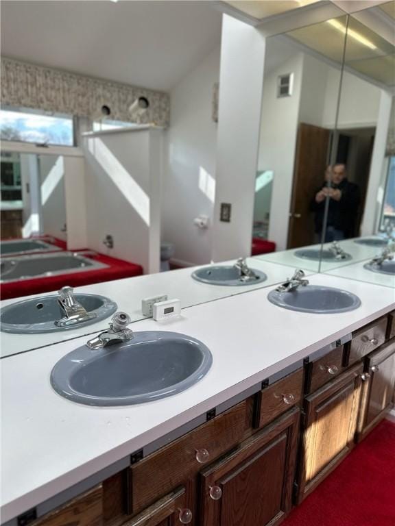 full bathroom featuring double vanity and a sink