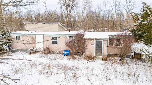 view of snow covered rear of property