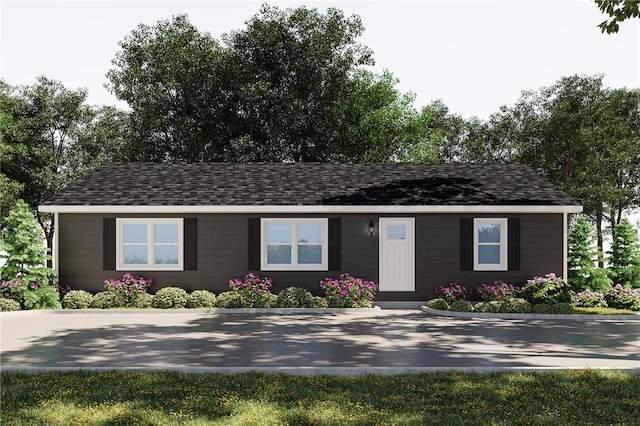 ranch-style house featuring roof with shingles