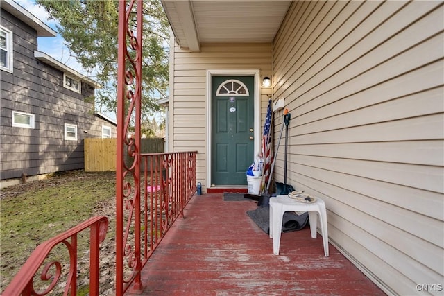 doorway to property featuring fence