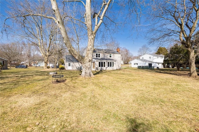 view of yard featuring an outdoor structure and a fire pit