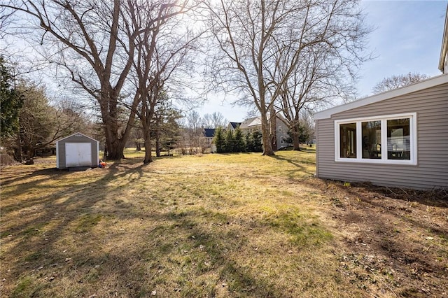 view of yard featuring an outbuilding and a shed