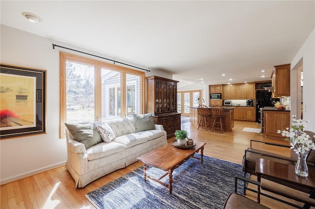 office space with light wood finished floors, a wainscoted wall, and ornamental molding