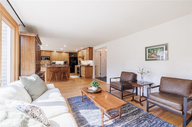 living room with recessed lighting and light wood-type flooring