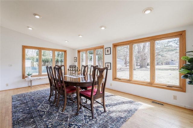 dining area with lofted ceiling, light wood-style flooring, recessed lighting, and visible vents