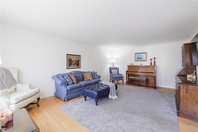 living area with light wood-style flooring and baseboards