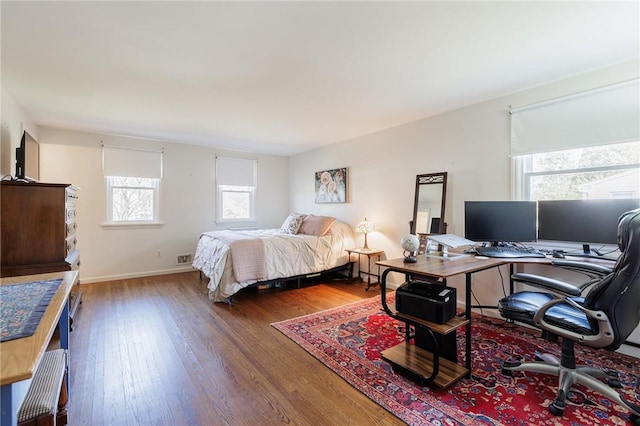 bedroom with baseboards and wood finished floors