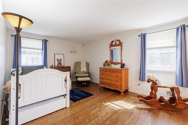 bedroom featuring baseboards and light wood-type flooring