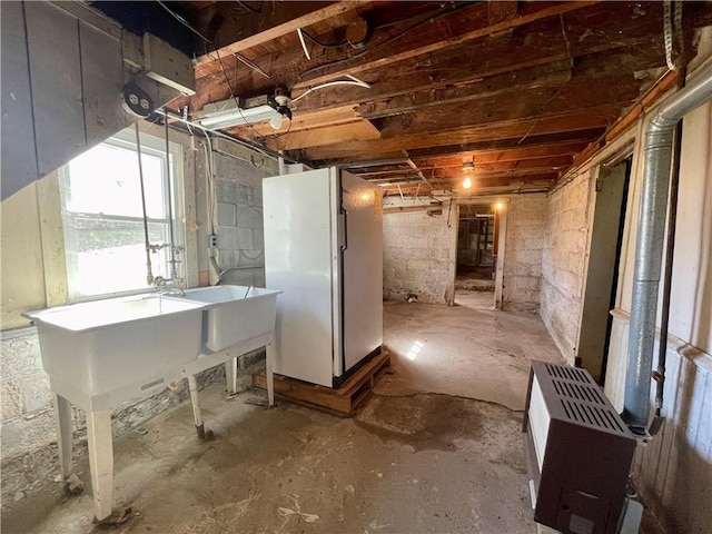 basement featuring freestanding refrigerator