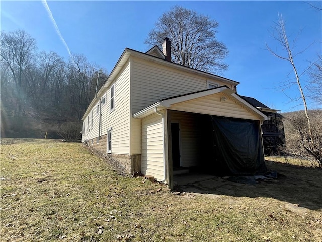 view of property exterior with a lawn and a chimney