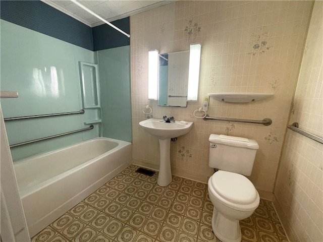 full bathroom with tile patterned flooring, tile walls, toilet, and shower / washtub combination