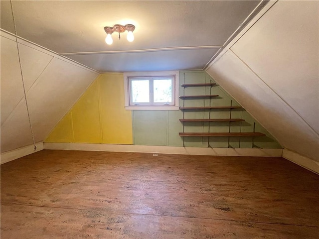 bonus room featuring wood finished floors and vaulted ceiling