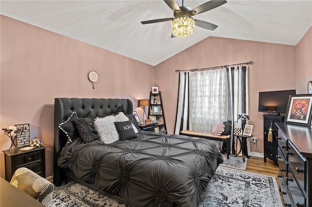 bedroom featuring wood finished floors, a ceiling fan, and vaulted ceiling