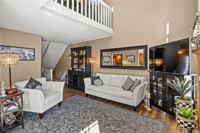 living room with a high ceiling and wood finished floors