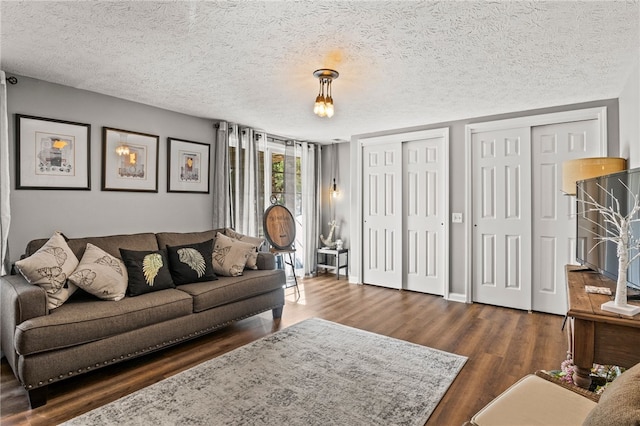 living area with a textured ceiling and dark wood-type flooring