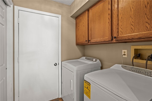 washroom featuring washer and dryer and cabinet space