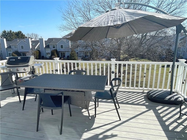 deck with outdoor dining area and area for grilling