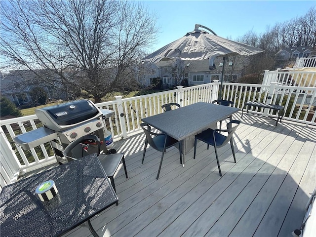 wooden deck featuring grilling area and outdoor dining area