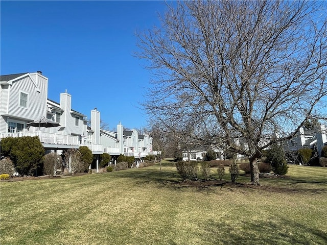 view of yard with a deck and a residential view