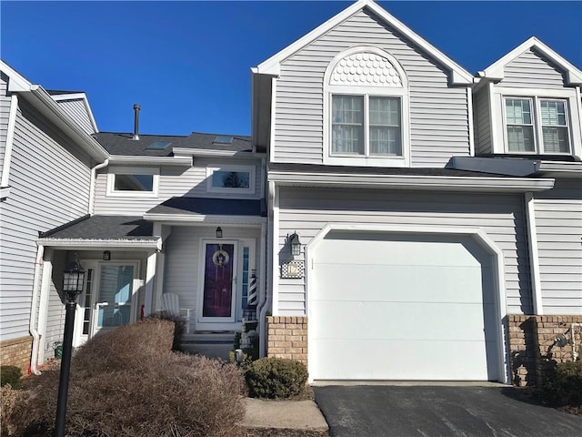 view of front of house with aphalt driveway and a garage