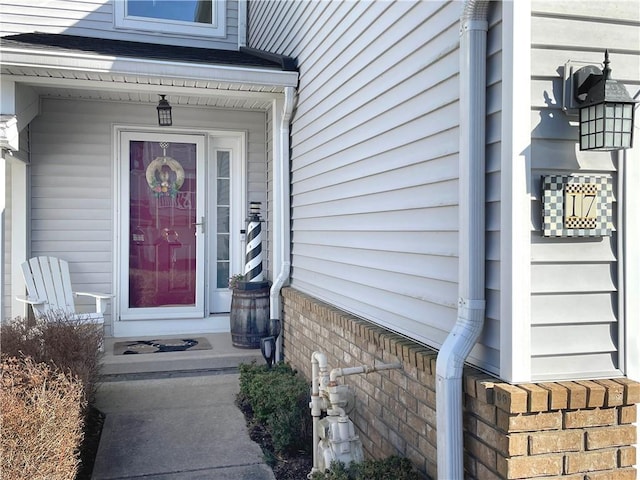 doorway to property with brick siding