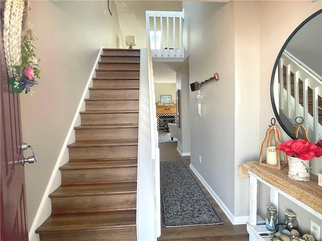 stairs featuring baseboards and wood finished floors