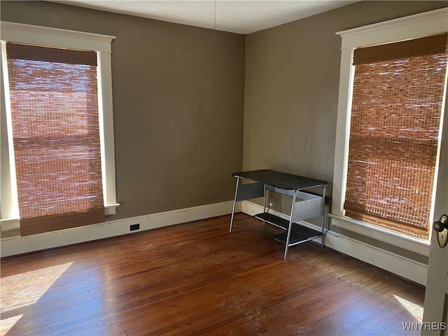 interior space with hardwood / wood-style flooring and baseboards