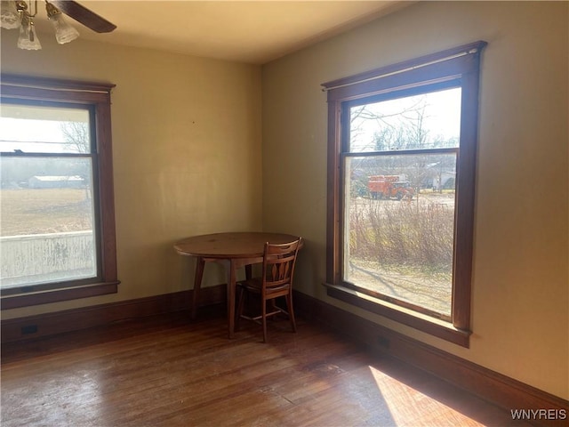 dining area with a ceiling fan, wood finished floors, baseboards, and a wealth of natural light