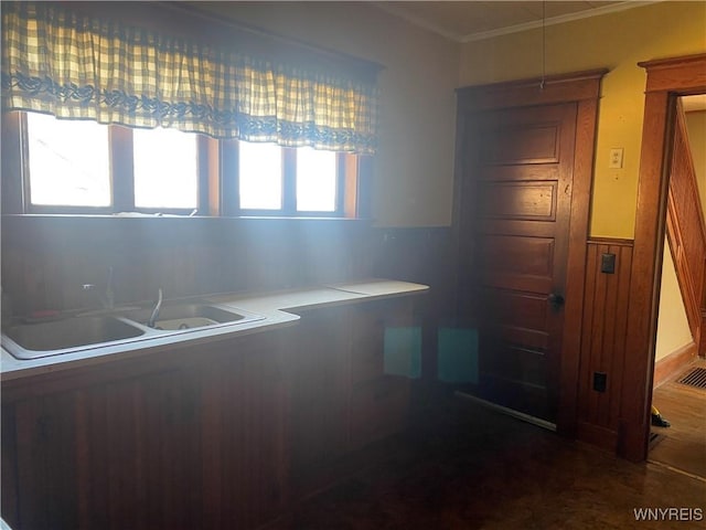 kitchen with a wainscoted wall and ornamental molding