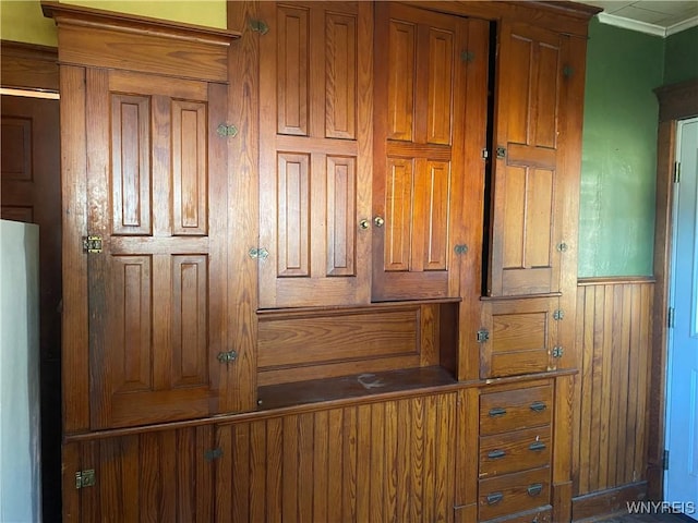 details with ornamental molding and freestanding refrigerator