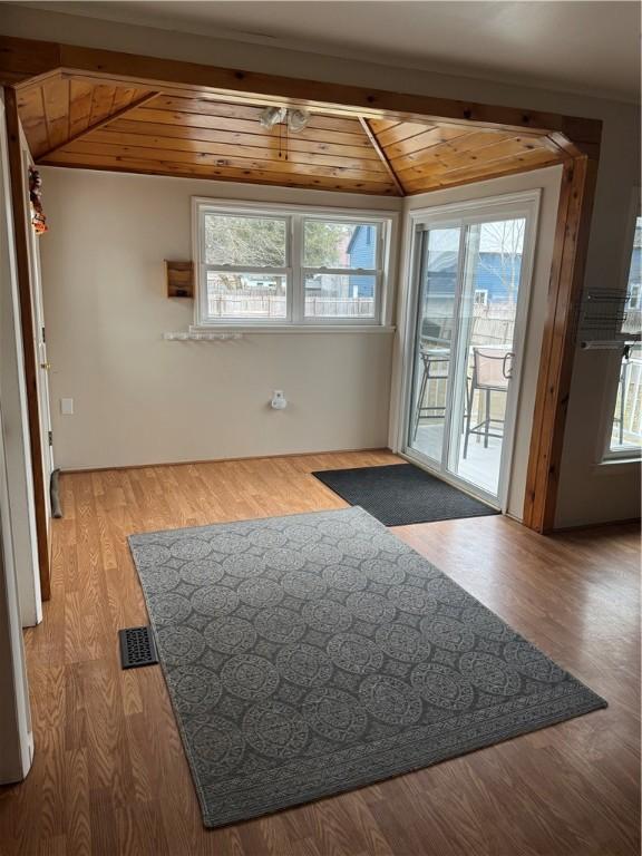 doorway to outside with wood finished floors, wood ceiling, visible vents, and vaulted ceiling