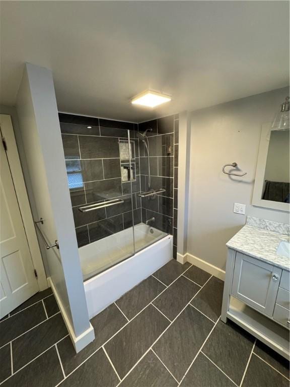 bathroom with vanity, tile patterned floors, washtub / shower combination, and baseboards