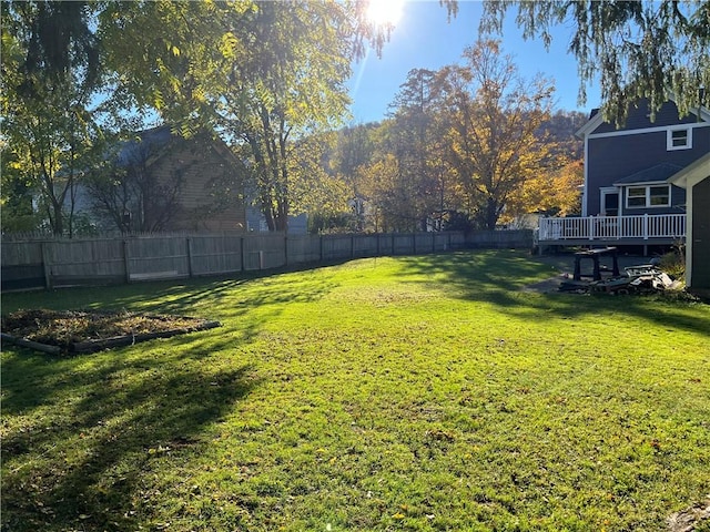 view of yard with a deck and fence