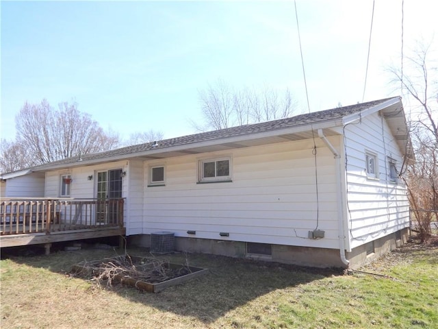 rear view of house featuring a yard, central AC, and a wooden deck