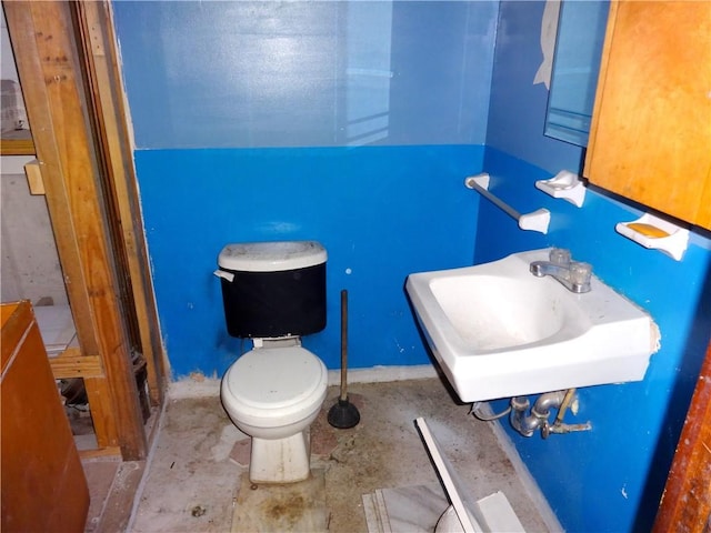 half bathroom with a sink and toilet