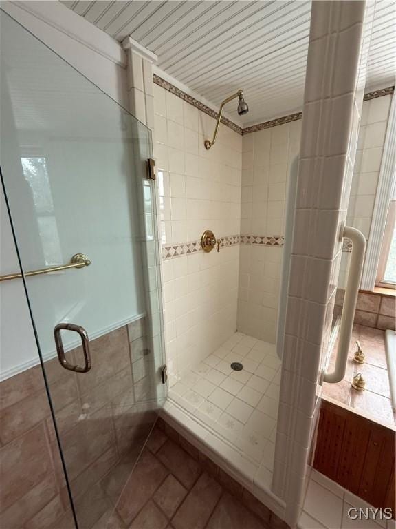 full bath featuring tile patterned floors and a shower stall