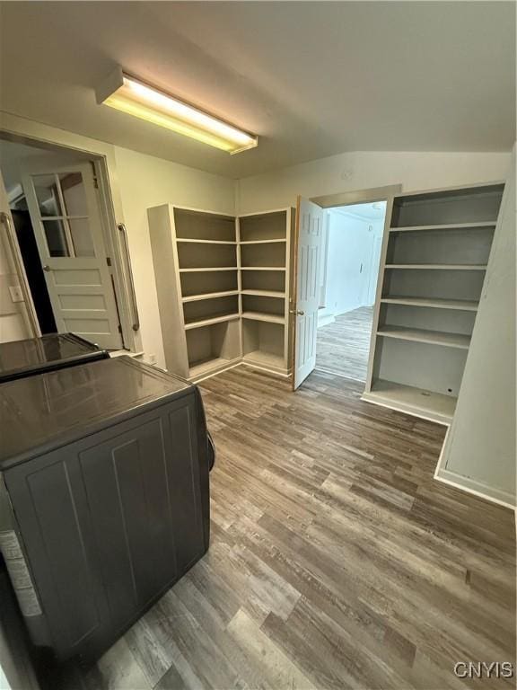 interior space featuring dark cabinets and wood finished floors