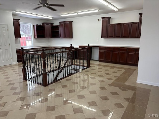 kitchen featuring open shelves, baseboards, dark brown cabinets, and a ceiling fan