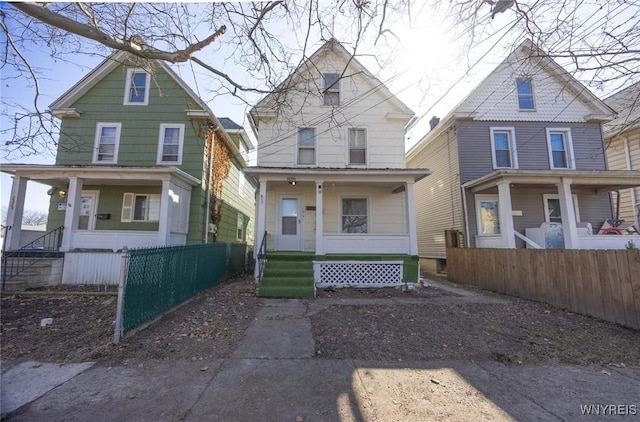 view of front of property with a porch and fence