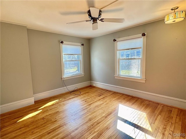 unfurnished room featuring baseboards, ornamental molding, and hardwood / wood-style flooring