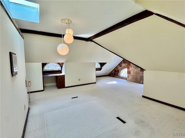 bonus room with baseboards, carpet floors, and vaulted ceiling with skylight