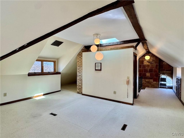 additional living space featuring baseboards, carpet floors, and lofted ceiling with skylight