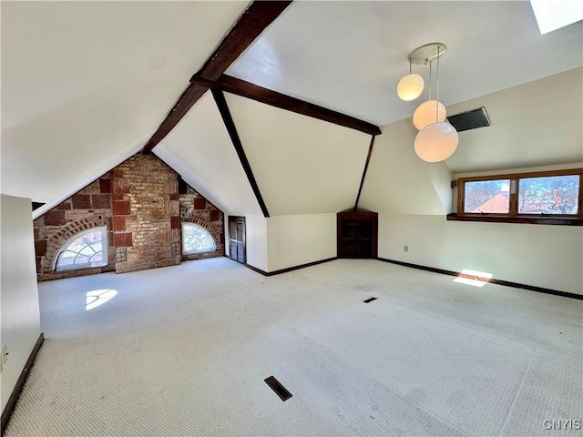 additional living space featuring a healthy amount of sunlight, vaulted ceiling with beams, and carpet