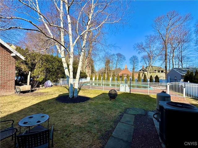 view of yard with fence and central AC